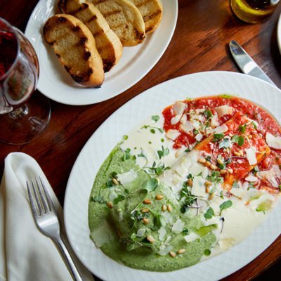 Stracciatella di Burrata with heirloom tomato and basil oil