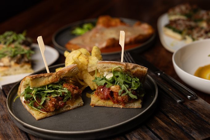 Italian sausage panino with arugula and house chips