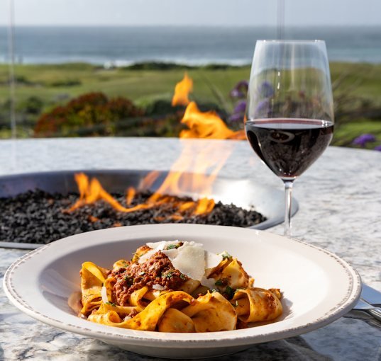 Pappardelle Bolognese beside the fire pit with an ocean view