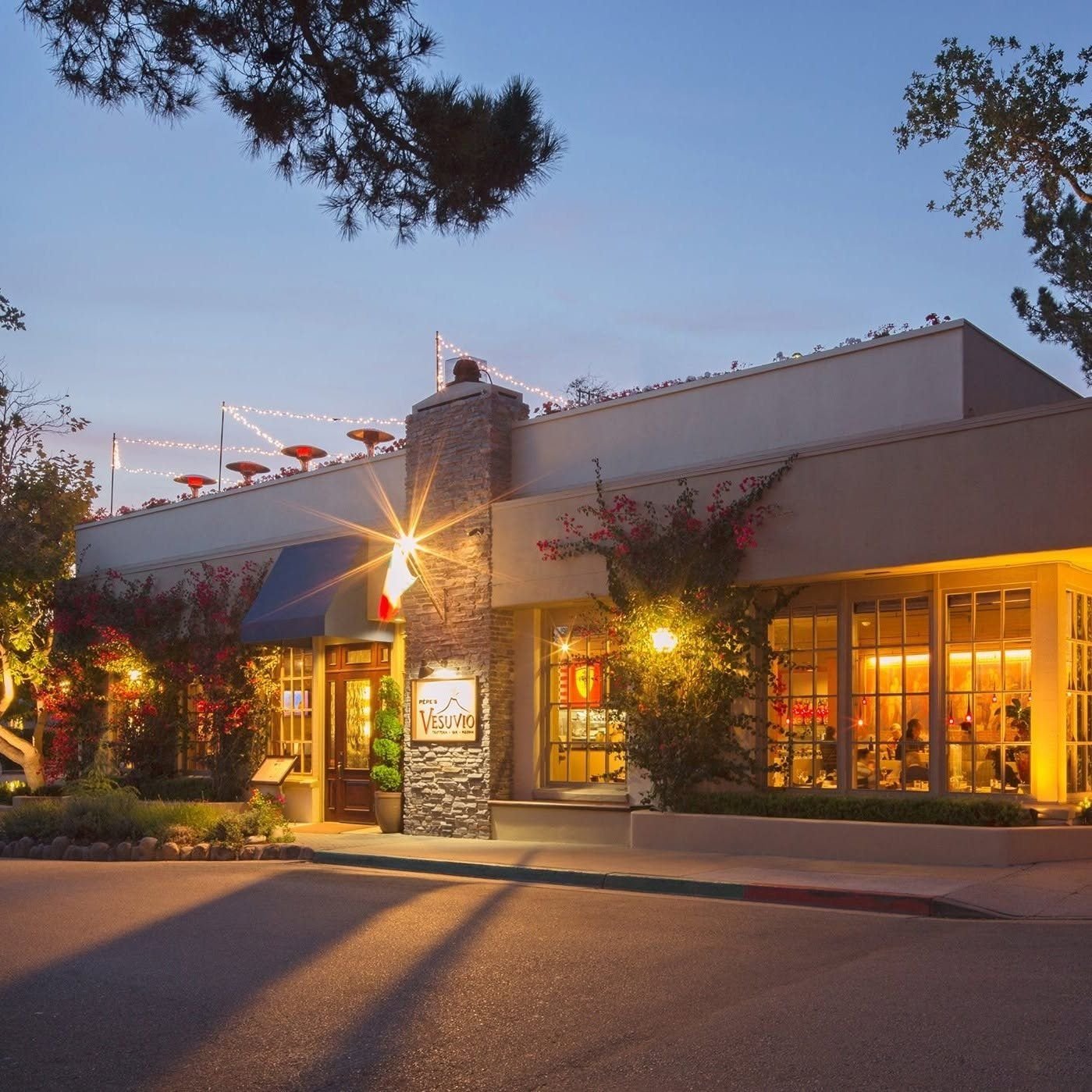 Pèpe's Vesuvio trattoria at dusk, string lights on the rooftop Star Bar in Carmel-by-the-Sea