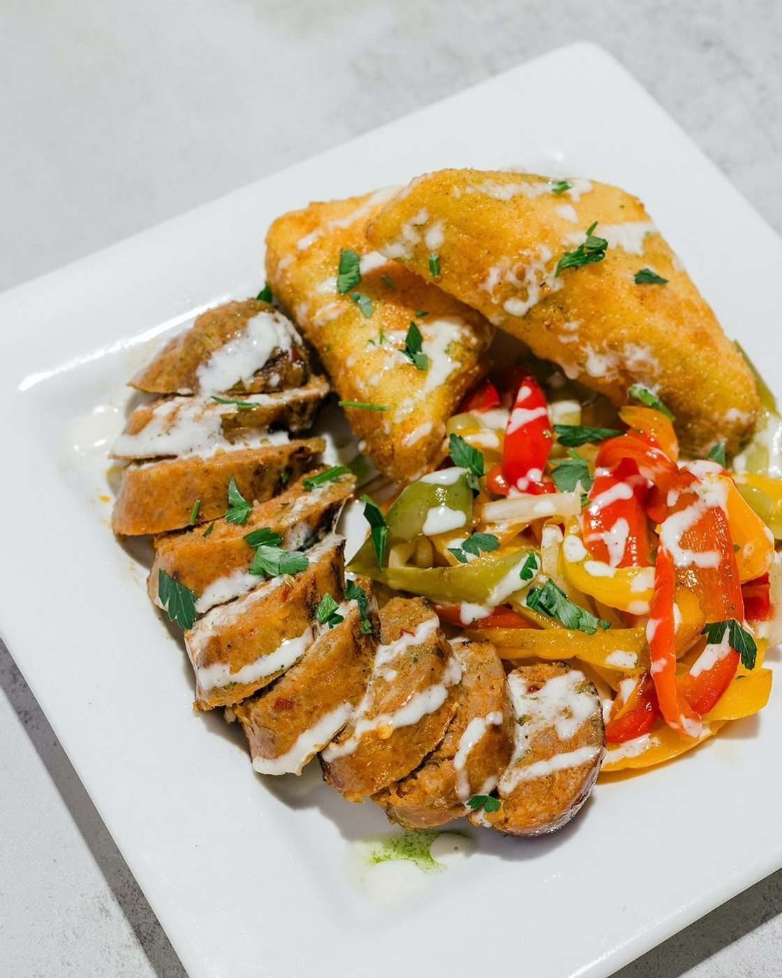 Italian sausage with peppers and fried artichoke crochette